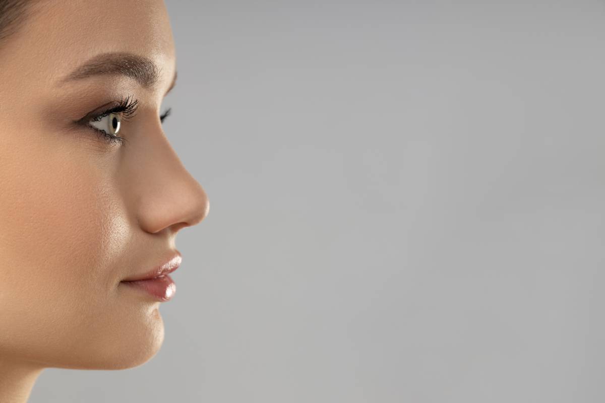 Attractive young girl on a gray background. Botox concept