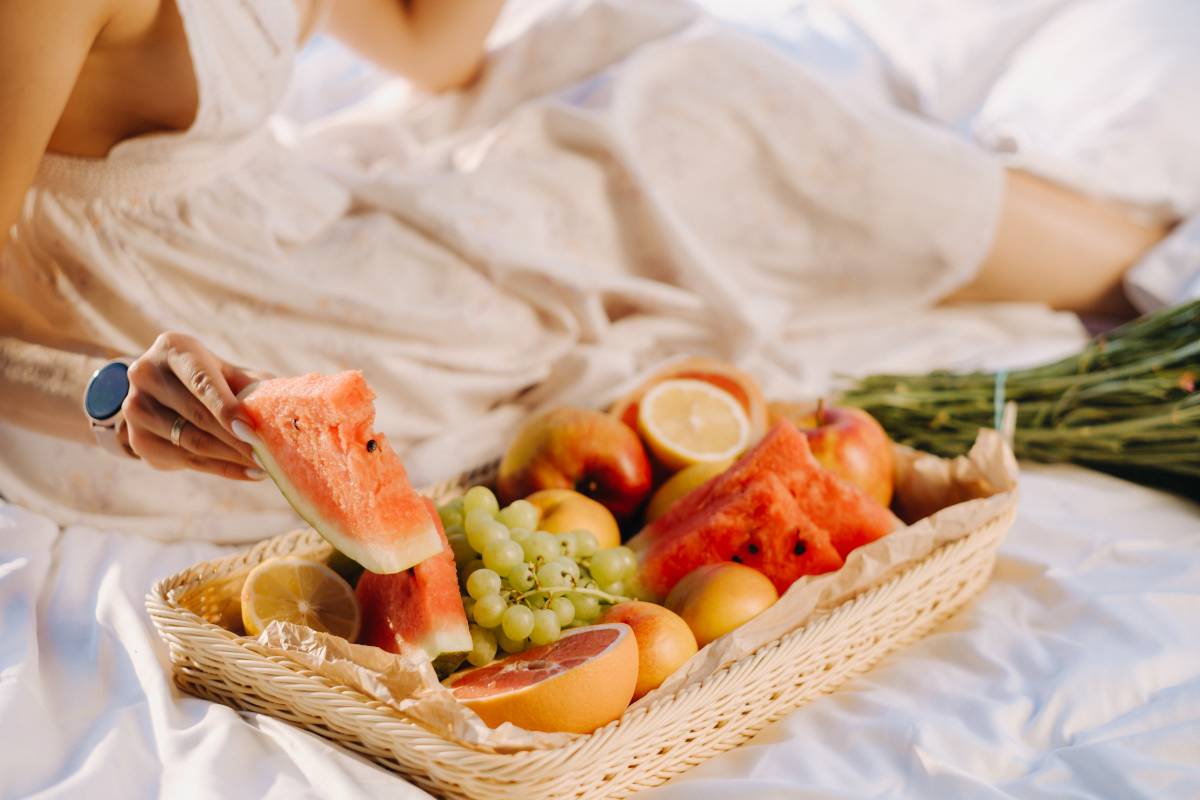 close-up of assorted fruits on a tray. The girl takes the fruit in her hands